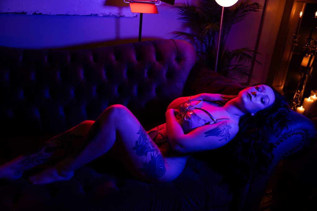 Woman laying on couch during a boudoir session
