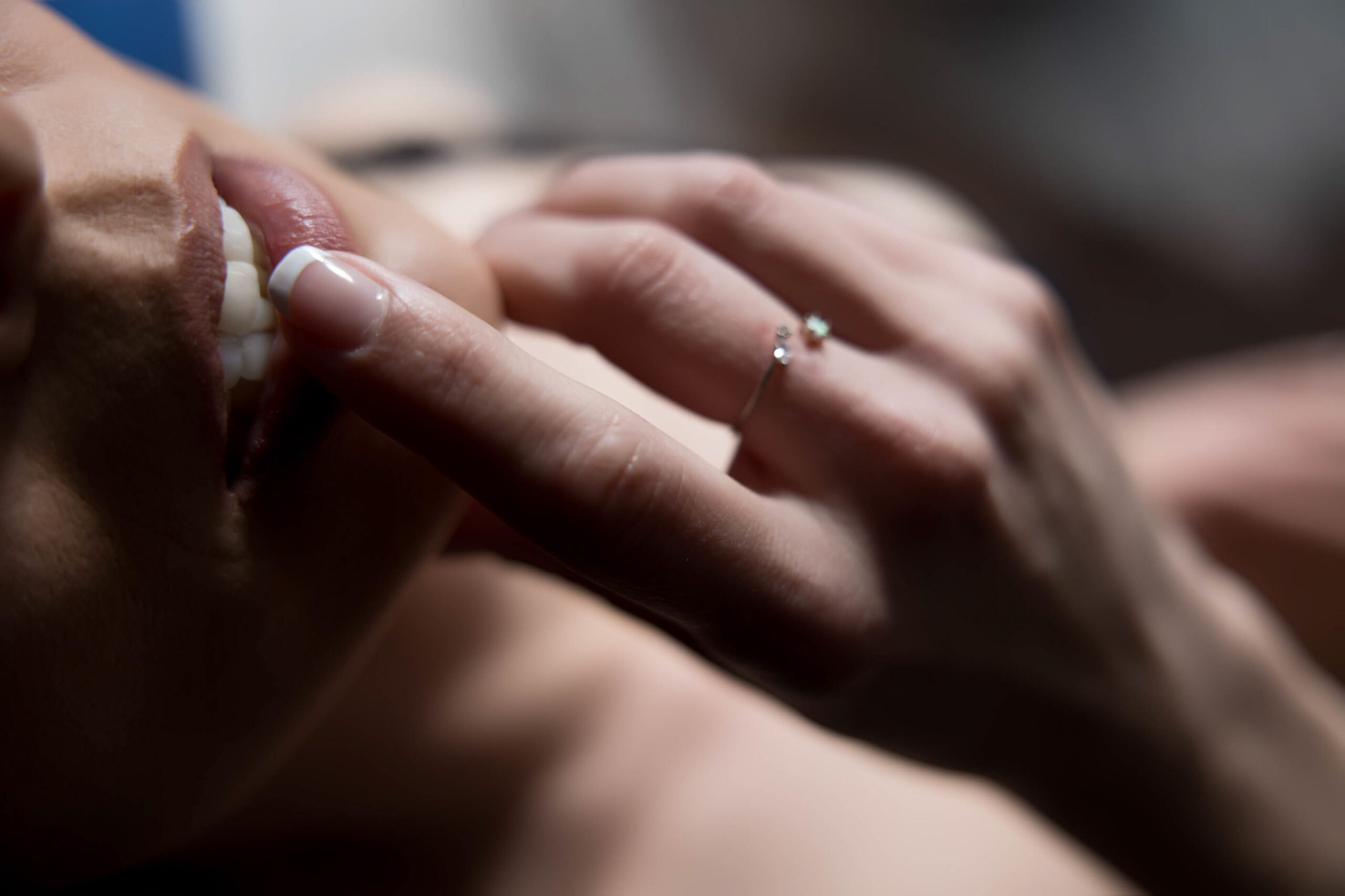 Details of a woman's finger on her lips