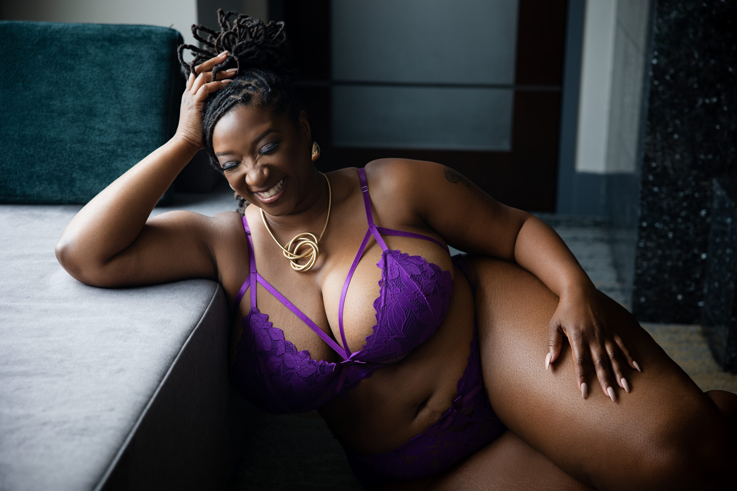 Woman smiling during her first boudoir session