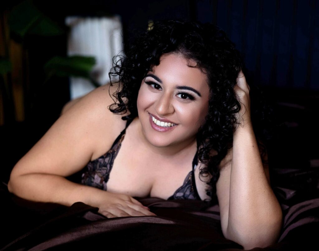 Woman smiling during a boudoir session in Maryland